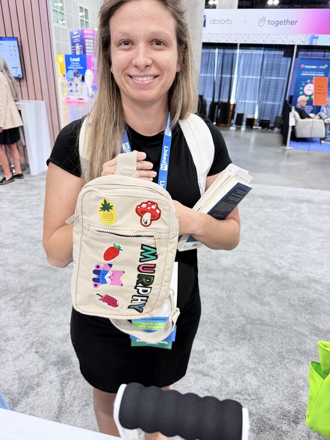 Guests picking up freshly printed canvas totes at an event swag station