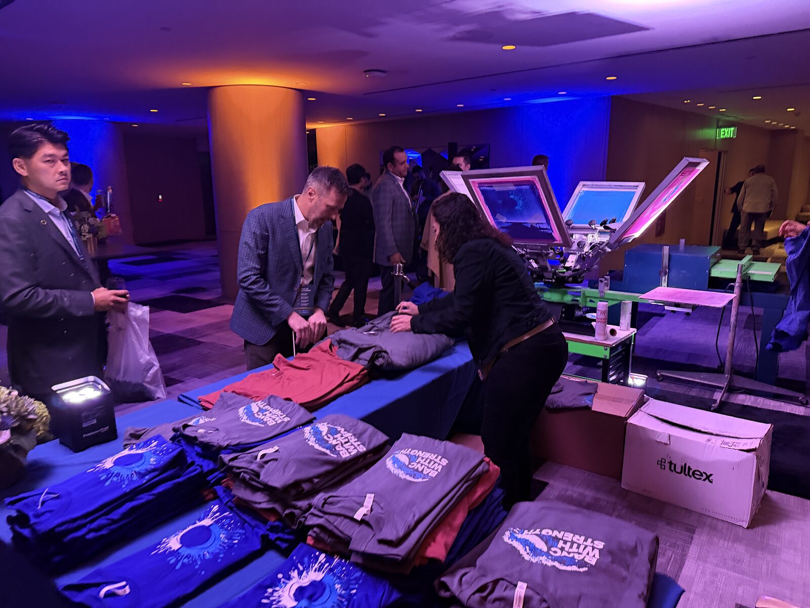 Executive summit merch table with printed event swag ready for guest pickup